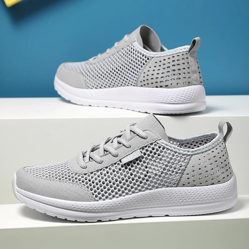 Pair of men's breathable gray mesh sport sneakers with white sole
