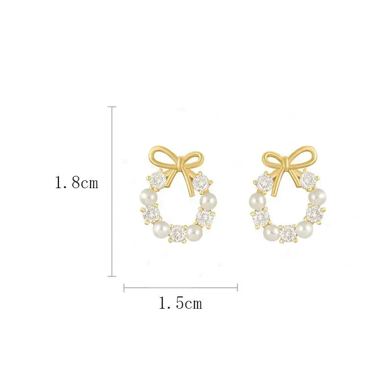 Hollow-out round rhinestone bow stud earrings with imitation pearls, gold-tone pair by Simples Market