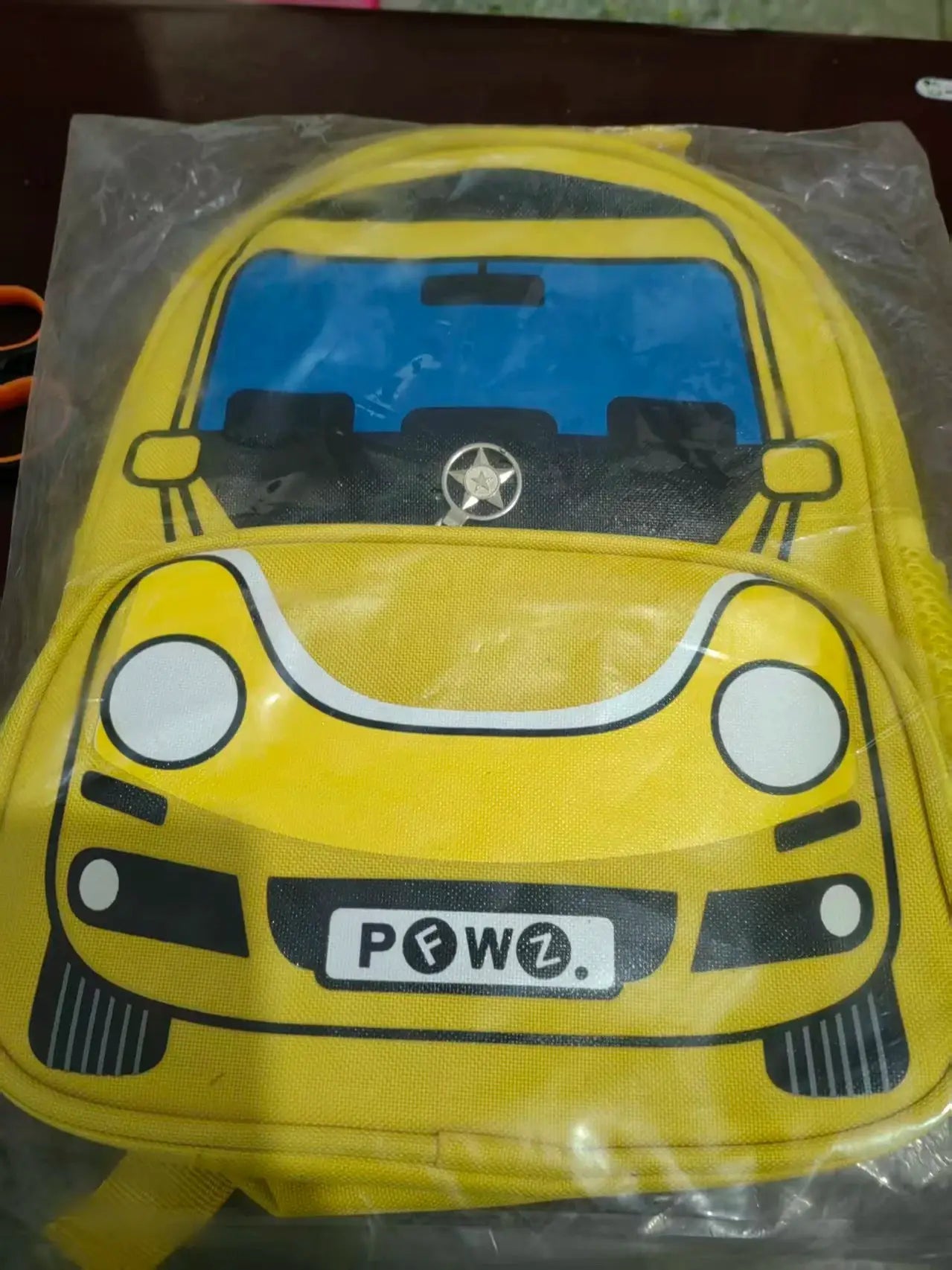 Children's police car backpack in bright yellow by Simples Market with blue windshield panel