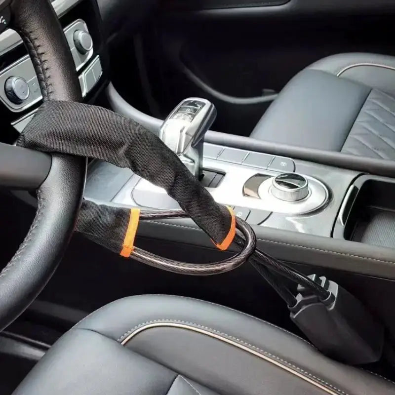 Simples Market steering wheel anti-theft lock with steel cable and black fabric wrap, includes 2 keys.