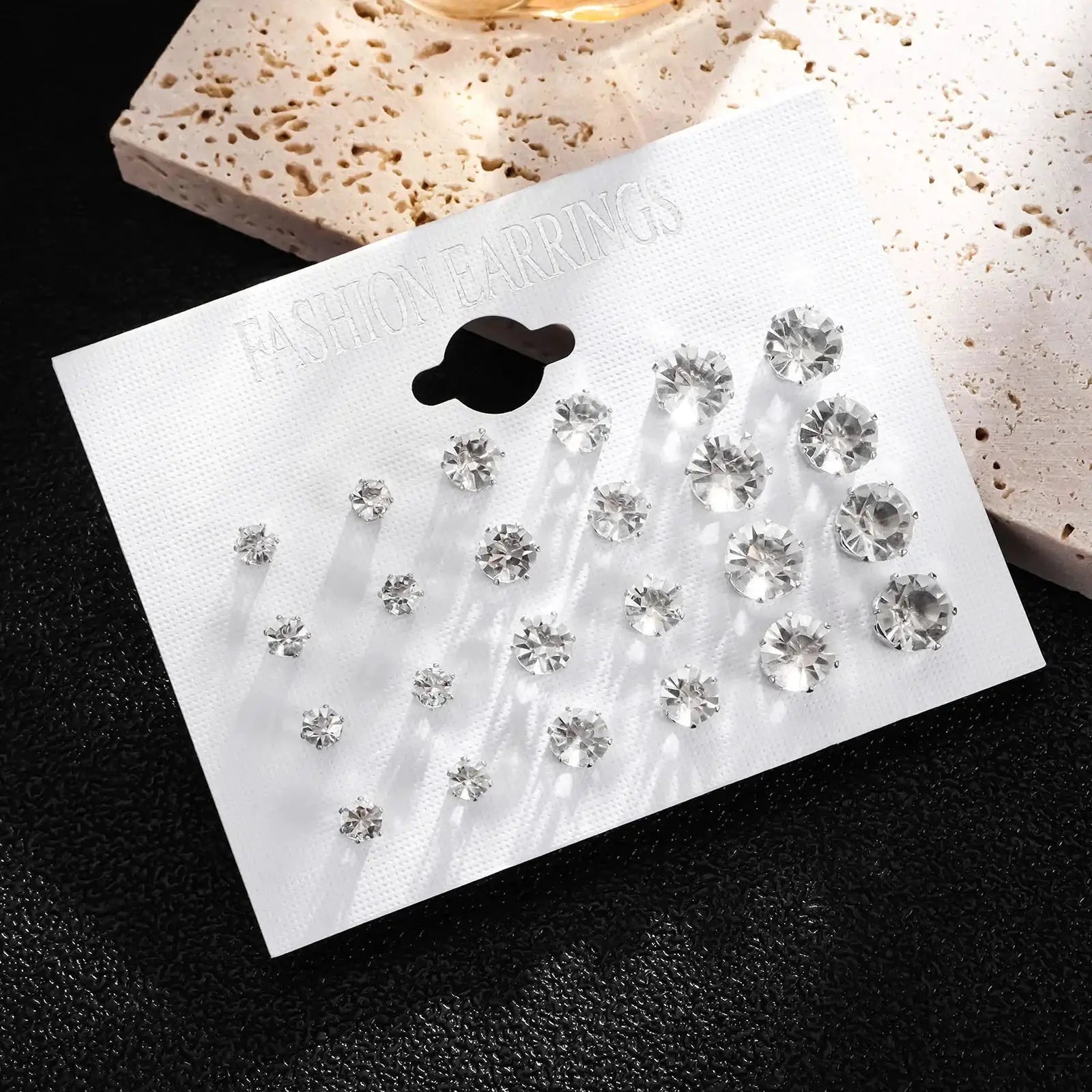 Crystal stud earrings set; 12 pairs of white clear rhinestones, assorted sizes on display card.