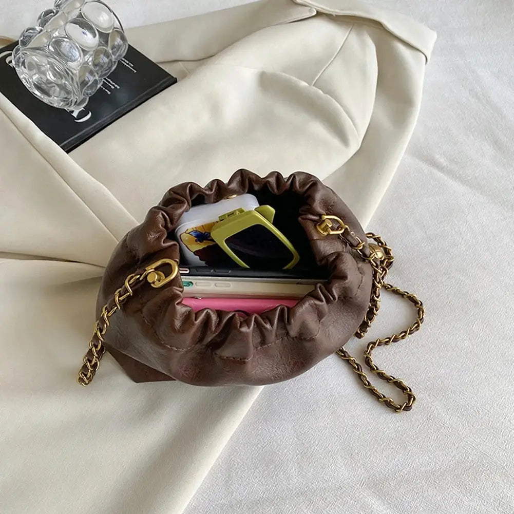 Women chain-shoulder bag with brown leather-look finish, gathered top, and gold chain strap.
