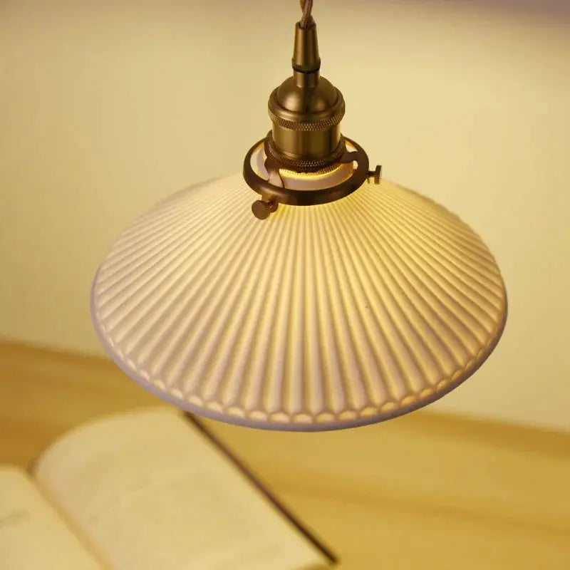 Pendant light with bronze hardware and ribbed frosted glass shade for living room