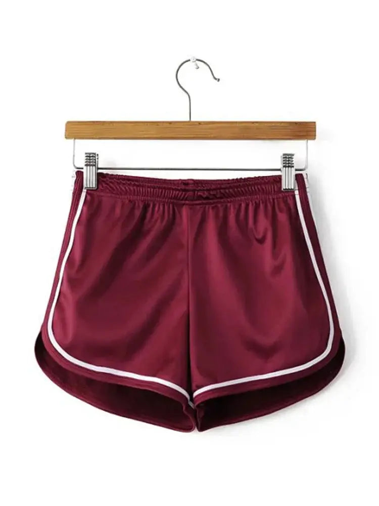 Women's silk shorts by Simples Market, burgundy with white piping and elastic waistband.