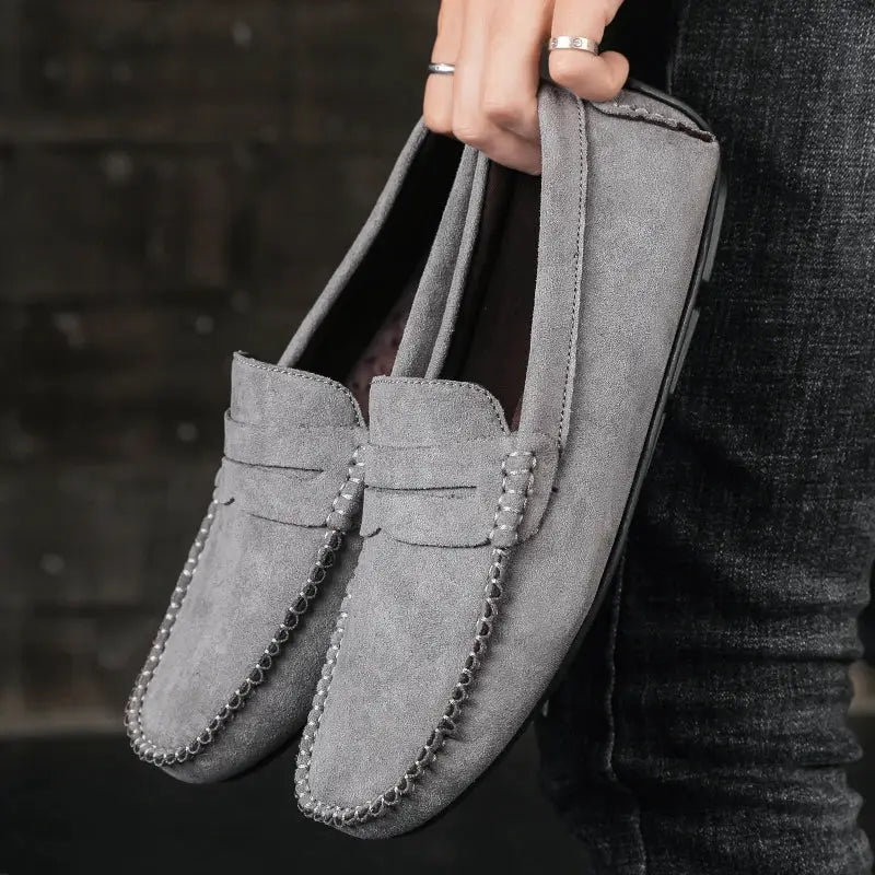 Pair of men's suede loafers by Simples Market; gray slip-on driving shoes with visible moccasin stitching