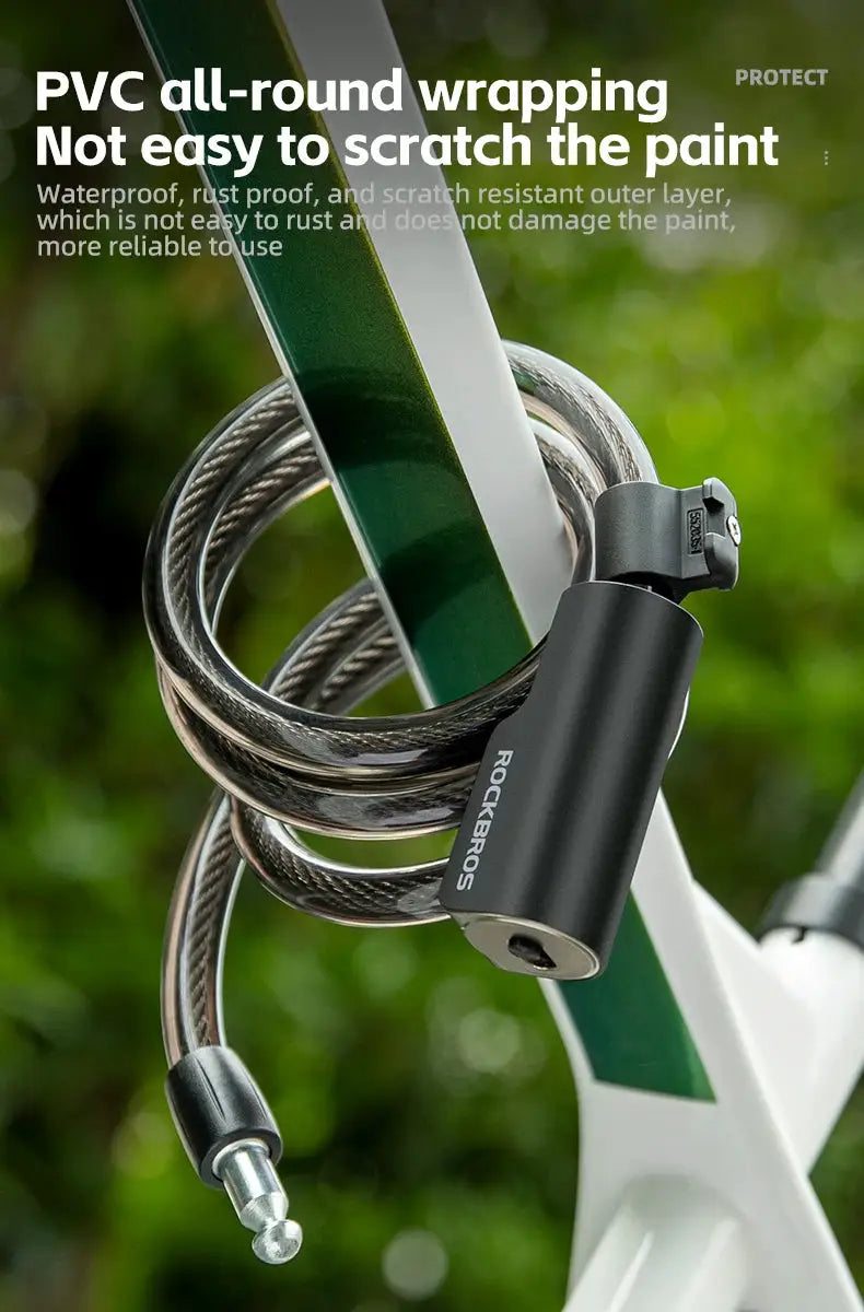 ROCKBROS bicycle lock with keys, black cylindrical body and braided steel cable secured to a bike frame