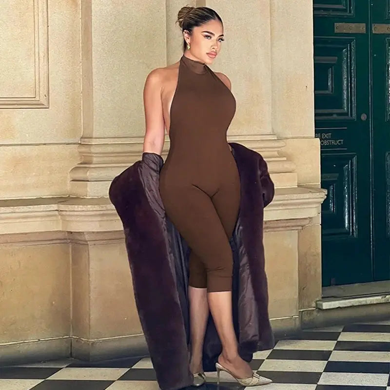 Jumpsuit brown ribbed halter-backless bodycon, knee-length, paired with a dark fur coat.