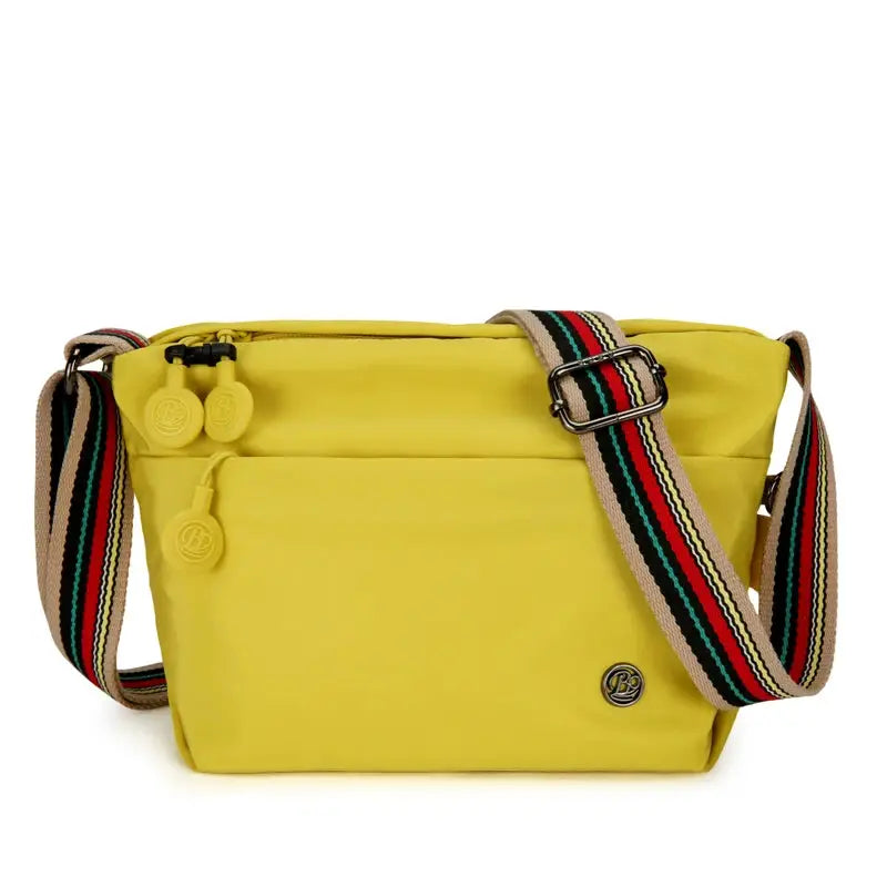 Ultra-light yellow nylon crossbody bag by Simples Market with adjustable striped strap and zipper closure.