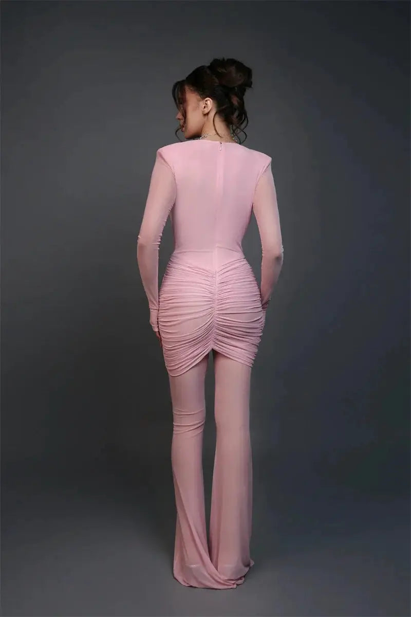 Pink long-sleeve ruched back-view jumpsuit for women with a fitted silhouette and flared legs