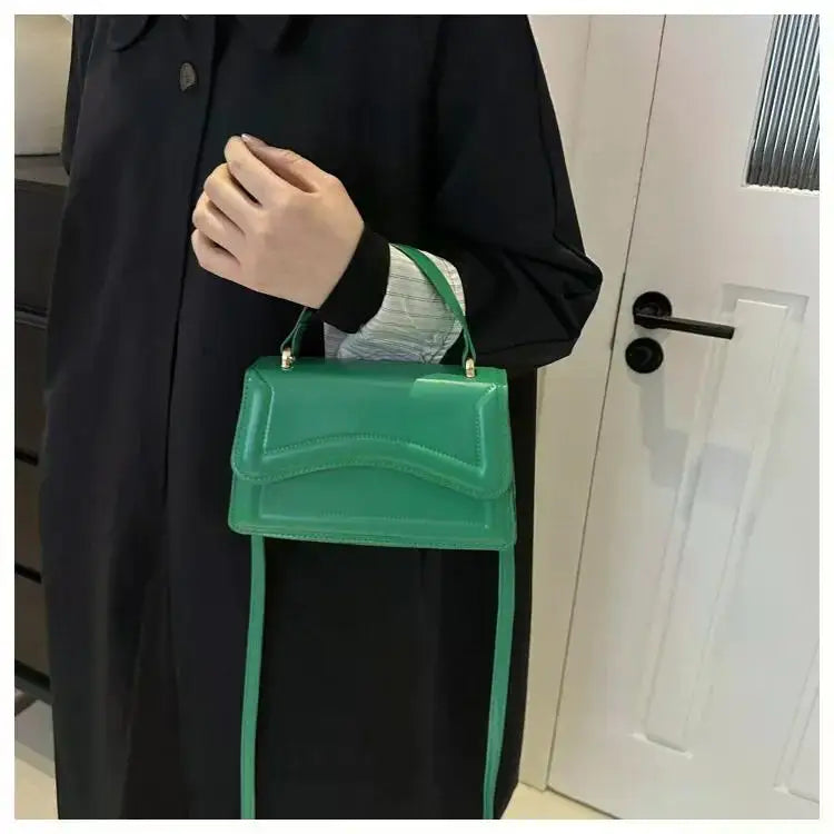 Green PU leather handbag with top handle and long crossbody strap by Simples Market