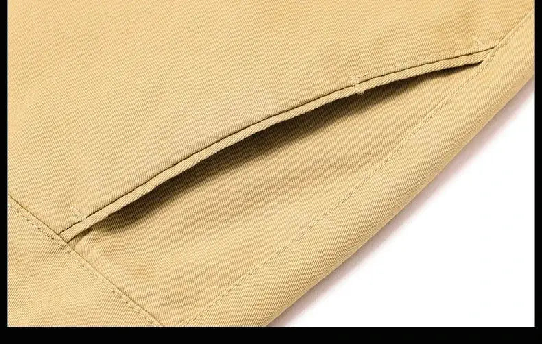 Men's khaki cotton pants close-up of pocket seam and fabric texture