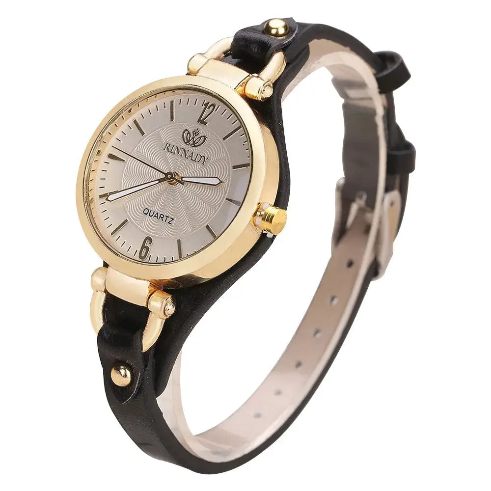 Women's Simples Market minimalist quartz watch; black leather strap, gold-tone case, silver dial.