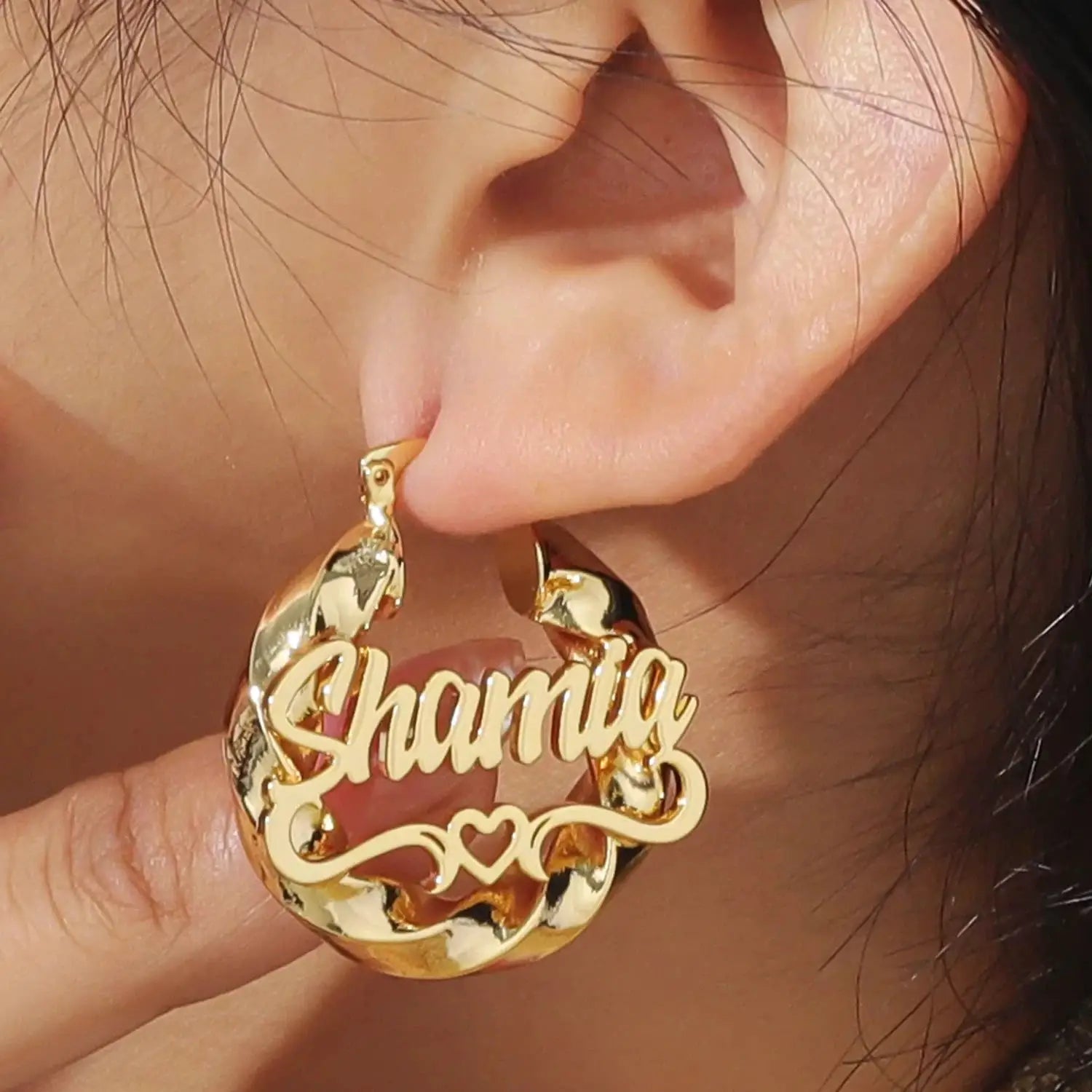 Gold-tone name hoop earring with twist design; pendant reads Shamia