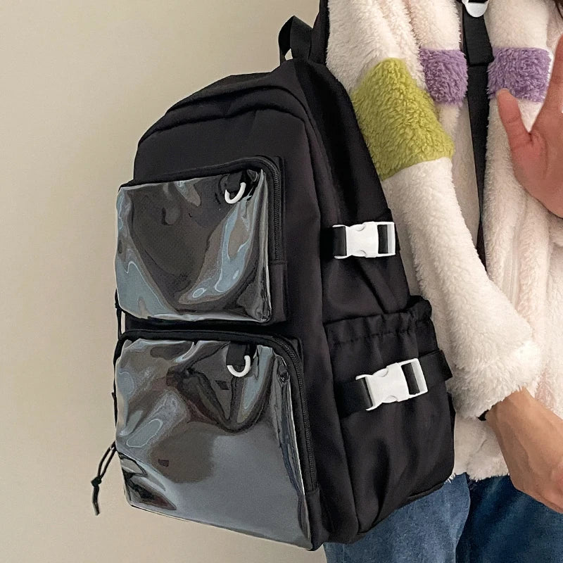 Japanese style transparent ita bag backpack, black with two clear front pockets and white buckle straps.
