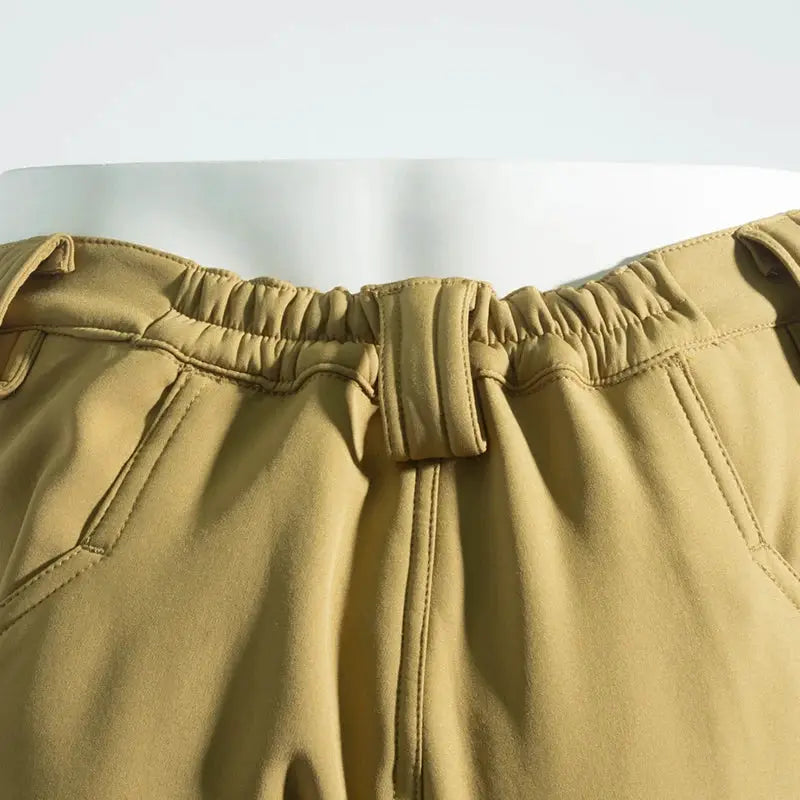 Men's beige Simples Market cargo hiking pants with elastic waistband and belt loops.