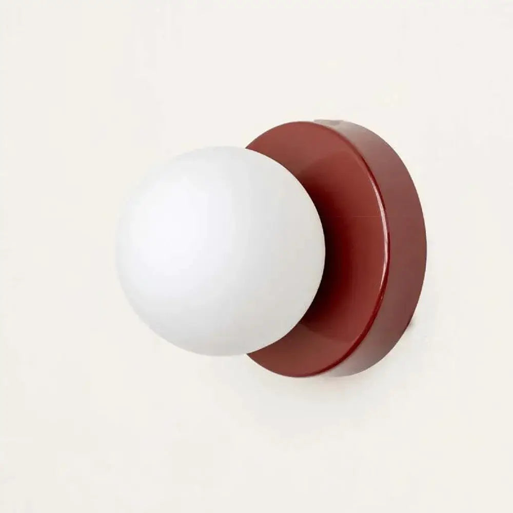 Nordic Macaron LED wall lamp by Simples Market; red round backplate with white glass globe sconce.
