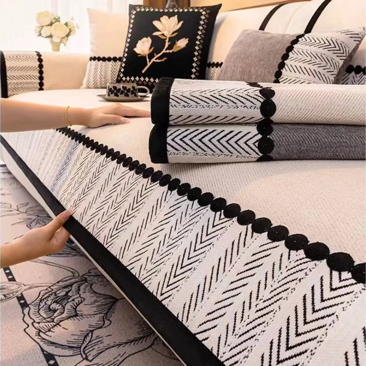 Sofa cover with contrast hem and black pom-pom trim in black-and-white twill chenille, all-season non-slip slipcover.