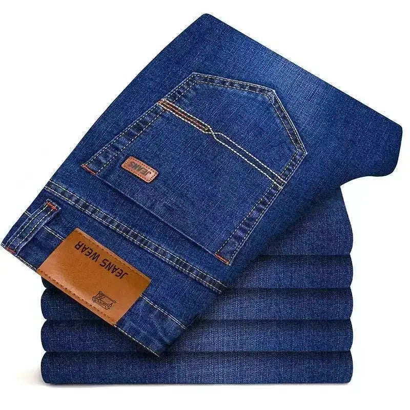 Men's blue denim jeans by Simples Market, stack of folded jeans with back pocket and brown leather patch