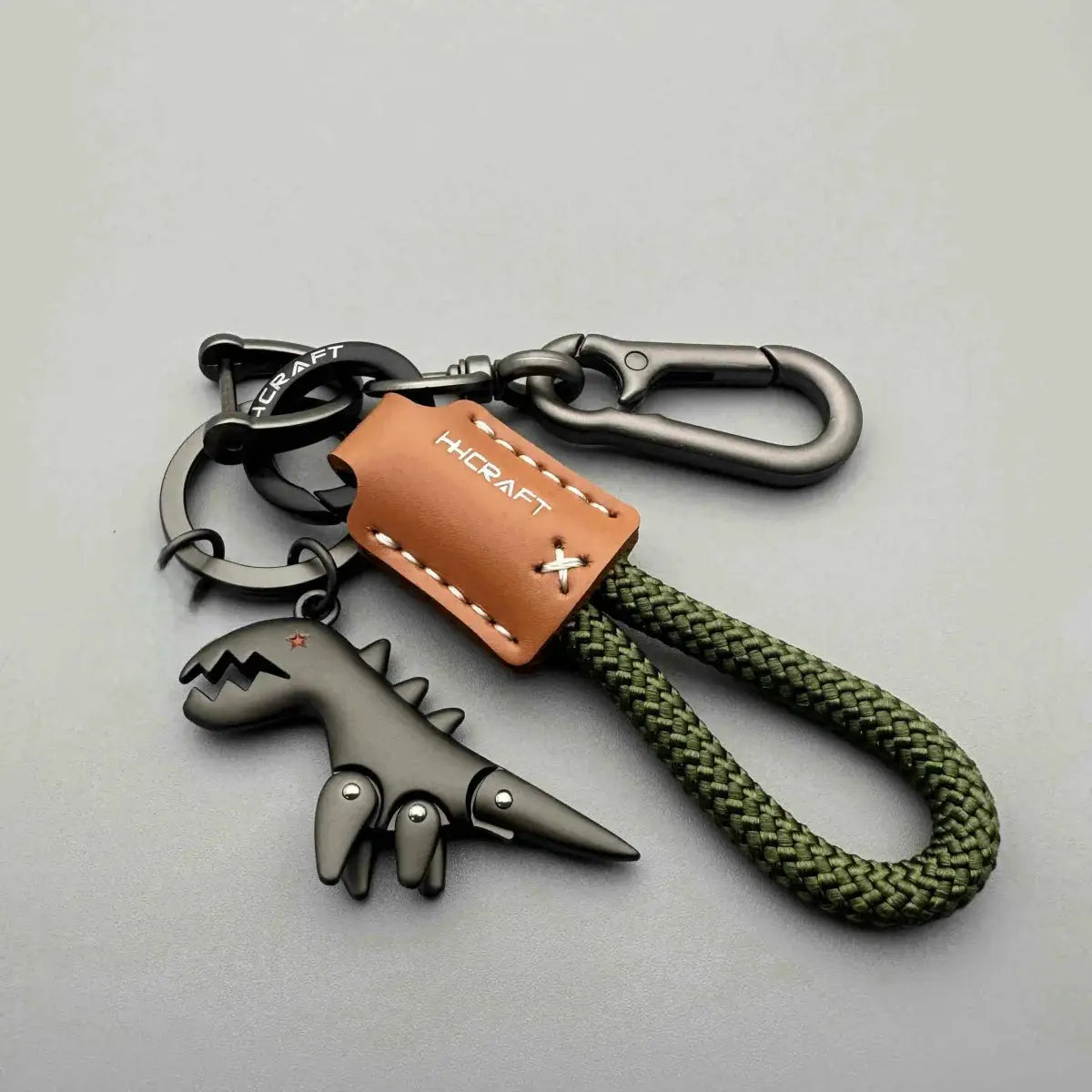 Motorcycle decor keychain with brown leather tag, green braided rope, and black metal clip by HCRAFT.