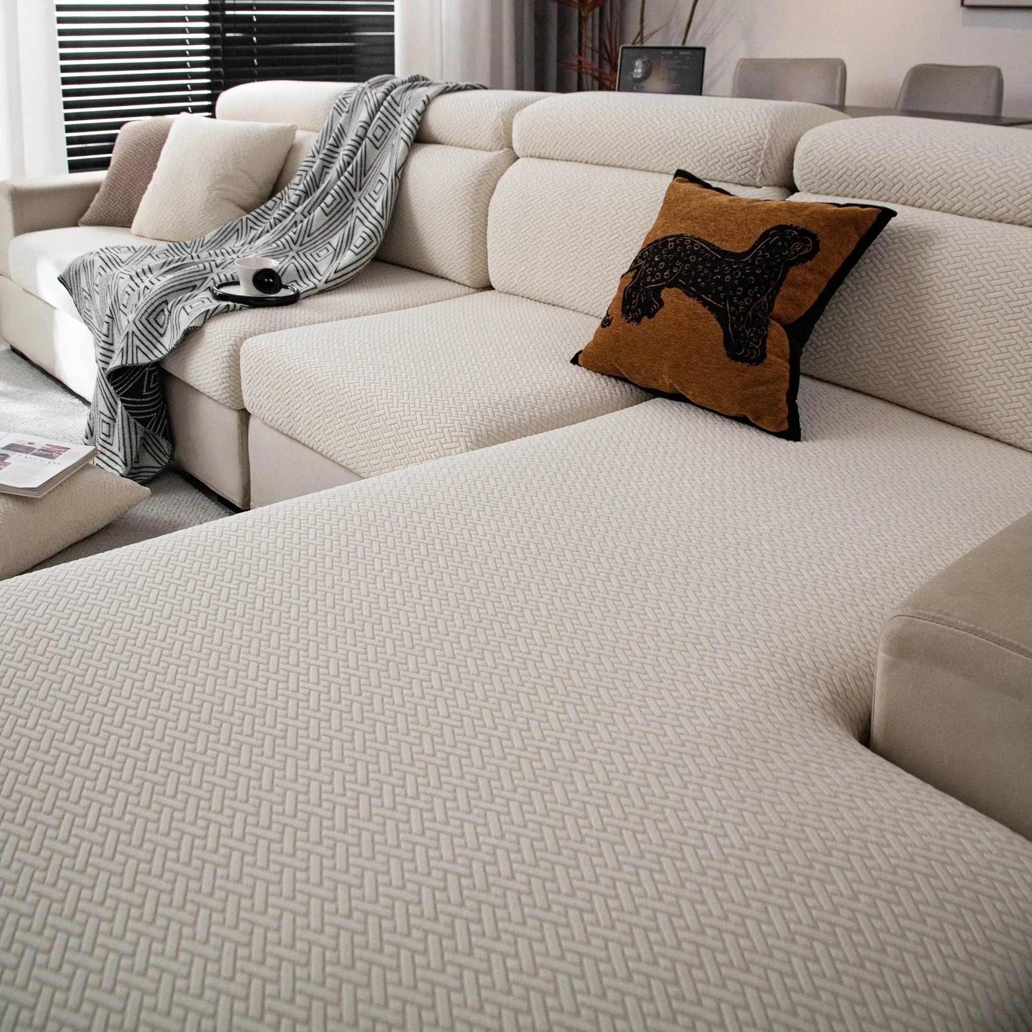 Stretchy polar fleece sofa slipcover by Simples Market for beige 3-seat sofa with geometric weave.