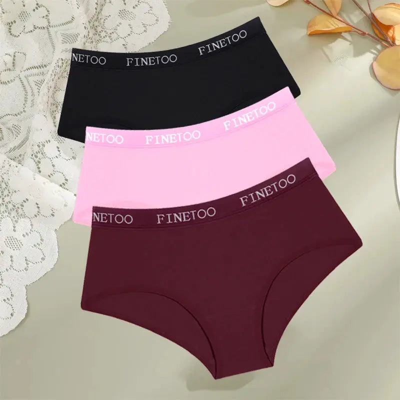Three FINETOO cotton women's panties in black, pink, and burgundy with branded waistband.