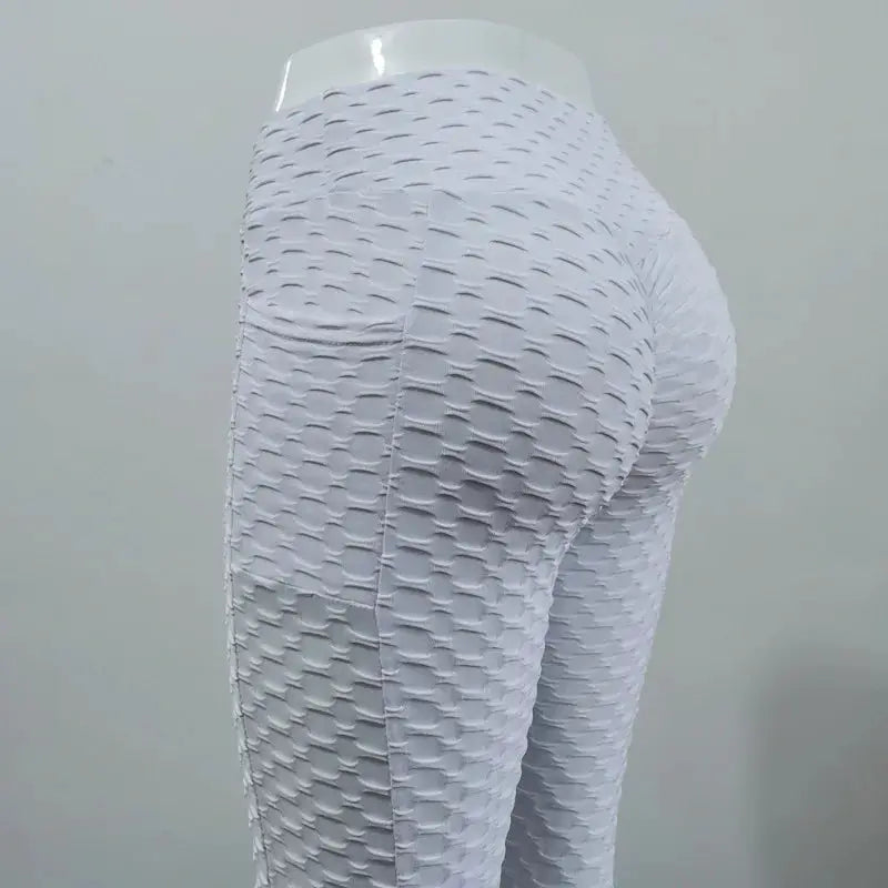 Women's bubble-textured white high-waisted leggings, stretchy slim-fit gym pants for active wear.