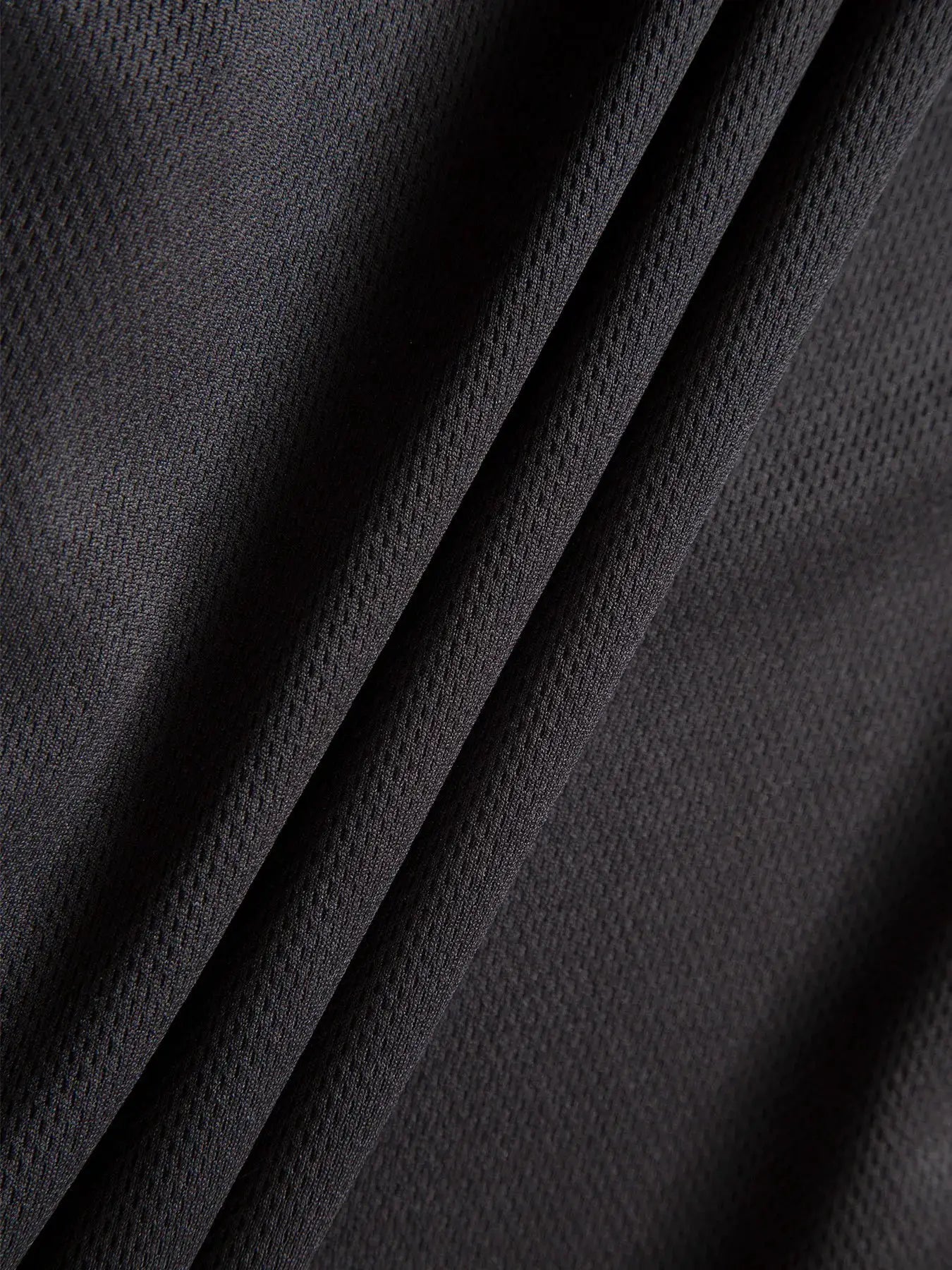Men's sports shorts fabric close-up in black mesh texture, Simples Market