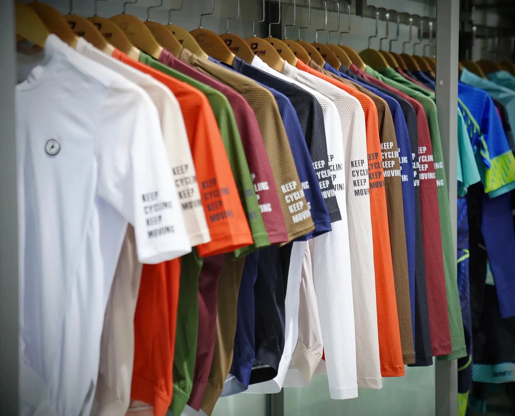 DAREVIE cycling jersey assortment on display; multicolor long-sleeve breathable training maillot