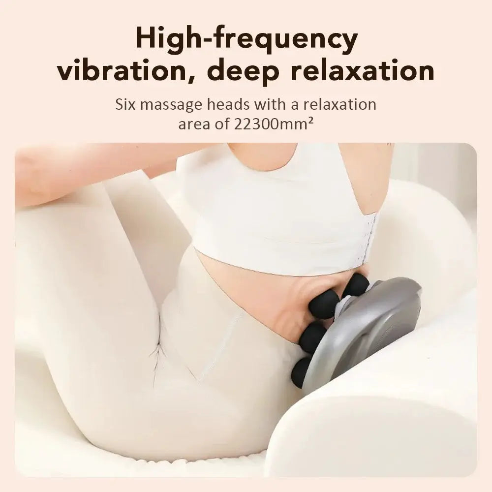 Electric fascia gun with six heads, grey body and black tips, used on the neck for deep tissue massage.