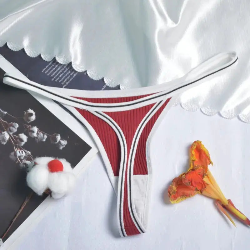 Women's red thong underwear by Simples Market with white trim, low-rise G-string