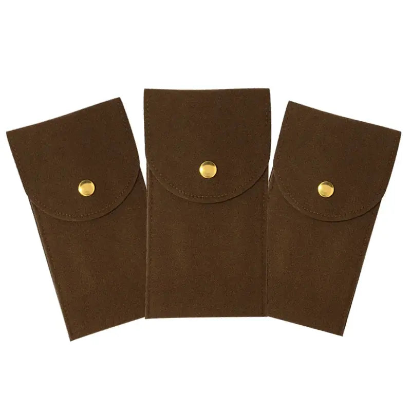 Three brown flannelette watch storage pouches with gold snap closures