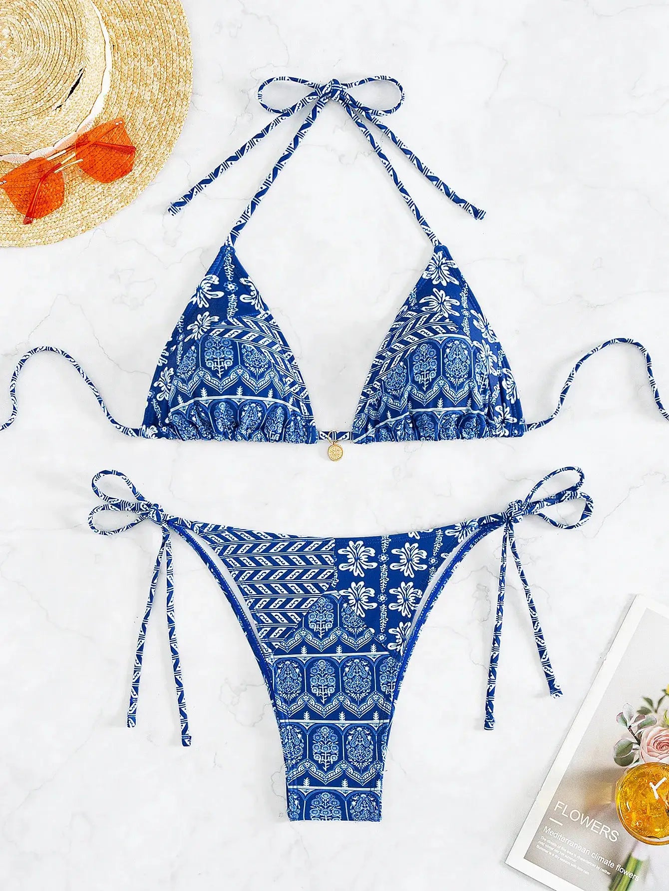 Bikini set by Simples Market; blue patterned two-piece with adjustable tie-side bottoms and halter triangle top.