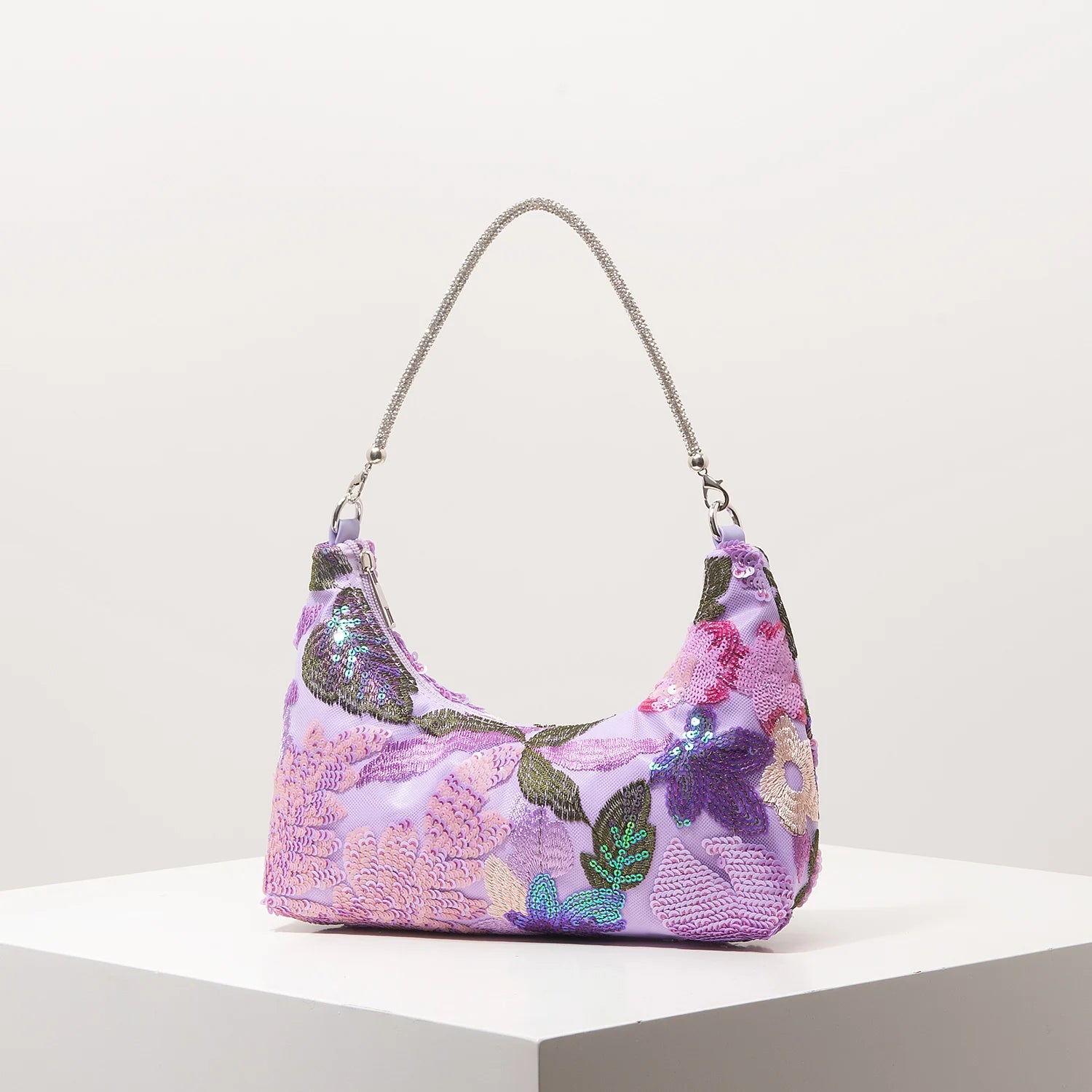 Shoulder bag with purple floral embroidery and sequins on lilac fabric, silver chain strap.