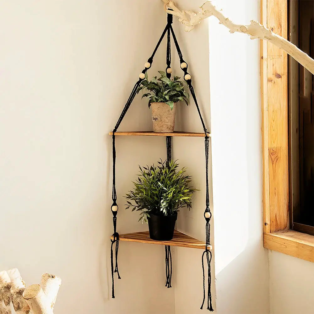 Floating two-tier wood wall shelf with black macrame hanger for boho decor, two potted plants