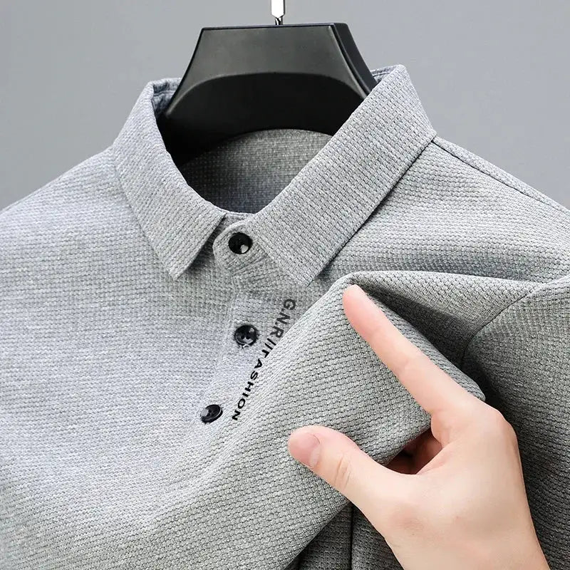 Men's grey waffle-knit polo shirt with long sleeves and a letter-printed placket, casual top