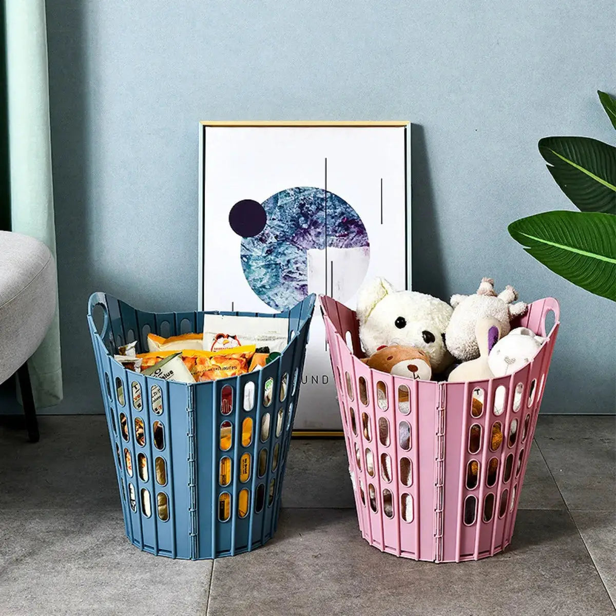 Two foldable laundry hampers in blue and pink, collapsible storage baskets filled with items