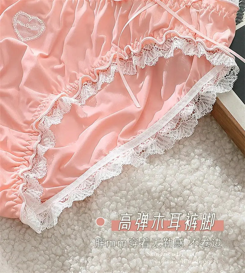 Pink satin panties with white lace trim and ruffled edge