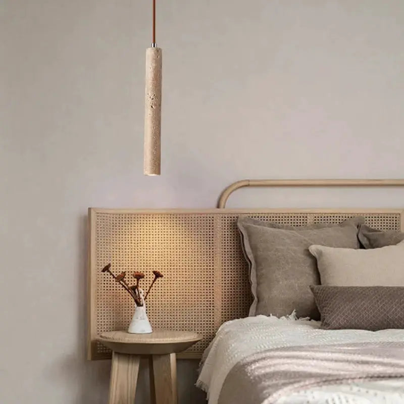 Wood-textured long-tube LED pendant lamp, Japanese-style bedside chandelier hanging from ceiling in a neutral bedroom.