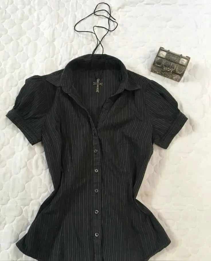 Women's black pinstripe short-sleeve button-down shirt by Simples Market and small metallic clutch