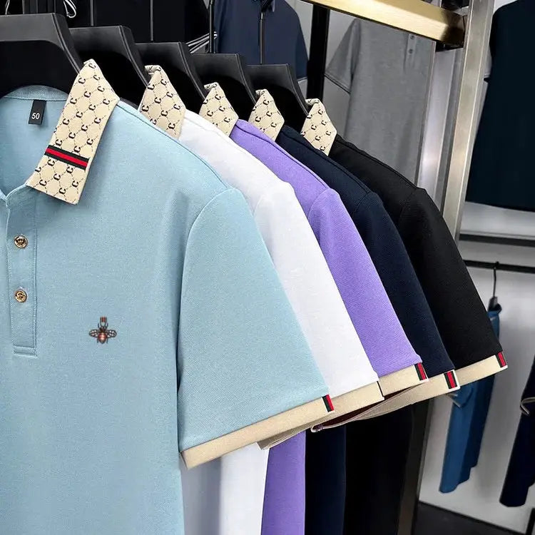 Men's polo shirts with patterned collars and bee embroidery in pastel colors on display