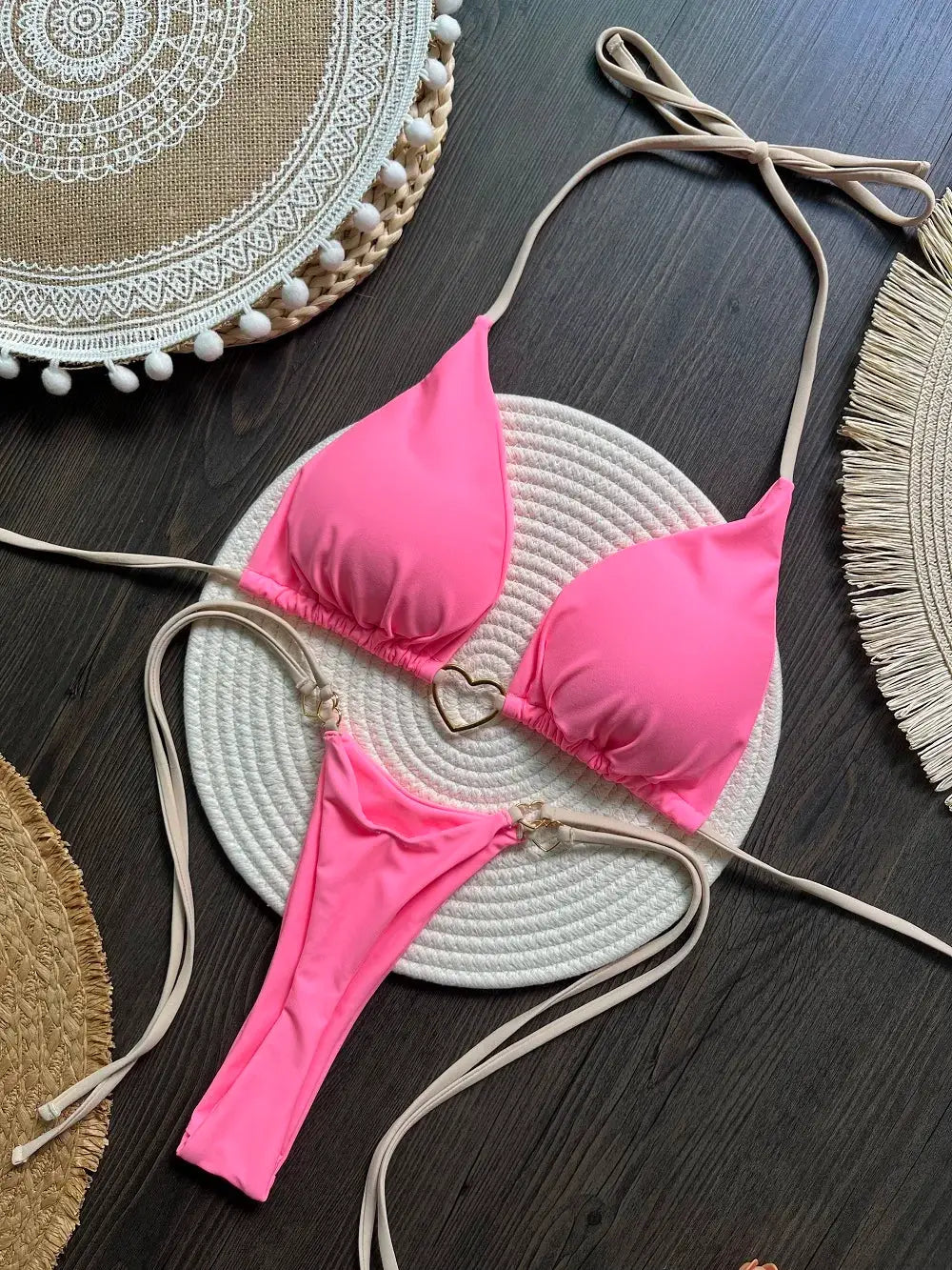 Pink bikini set for women, two-piece triangle halter top with thong bottoms.