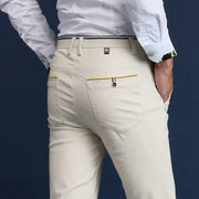 Men's Simples Market cotton chinos in light beige with yellow-trim back pockets.