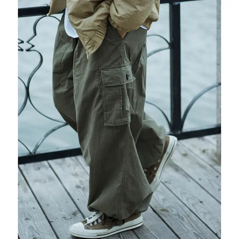 Cargo pants olive green oversized with multiple pockets, wide-leg ankle-length.