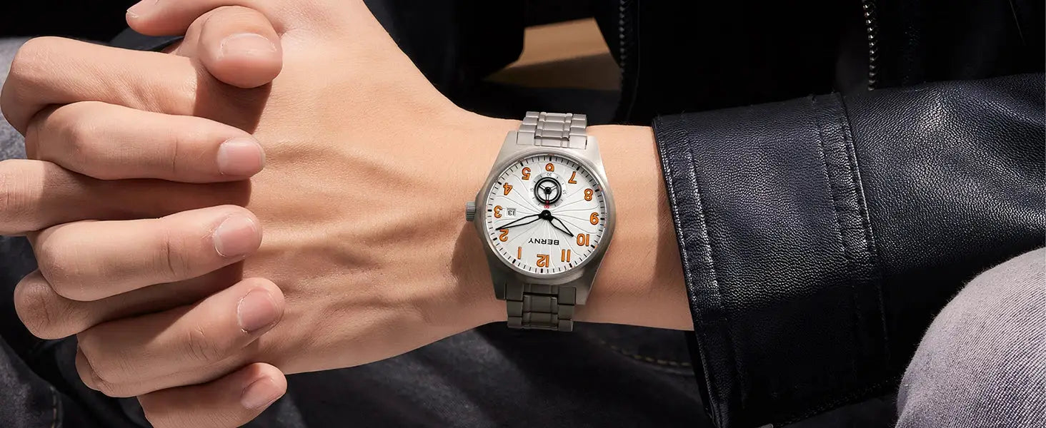 BERNY full titanium automatic men's watch on wrist; white dial with orange numerals and silver bracelet.
