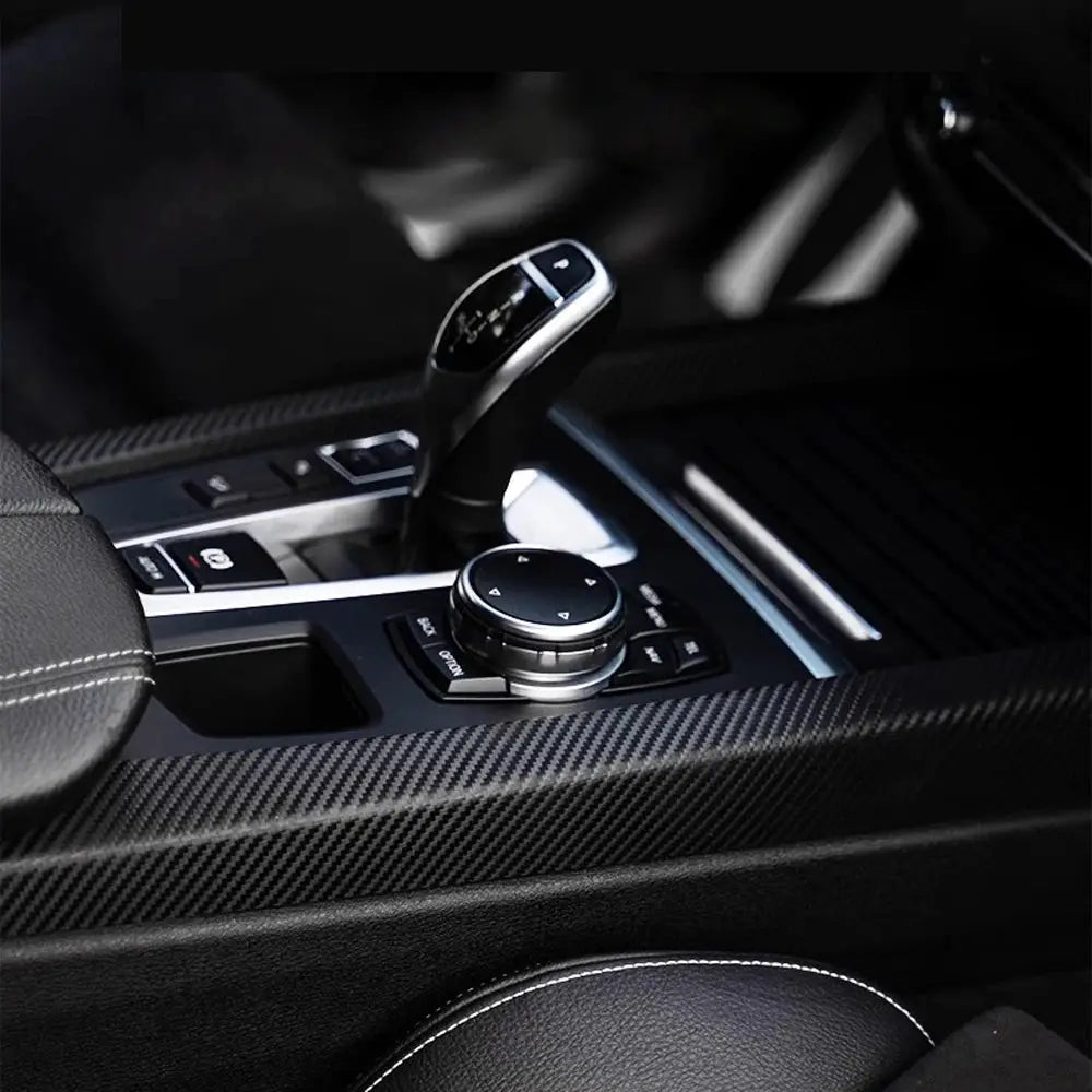 3D carbon fiber black vinyl wrap for car interiors; adhesive PVC film shown on center console and surrounding trim