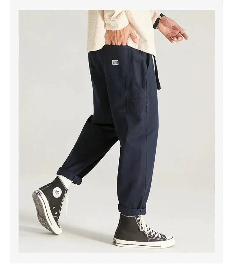 Men's navy HIQOR cargo pants with multiple pockets, belt loops and rolled cuffs.