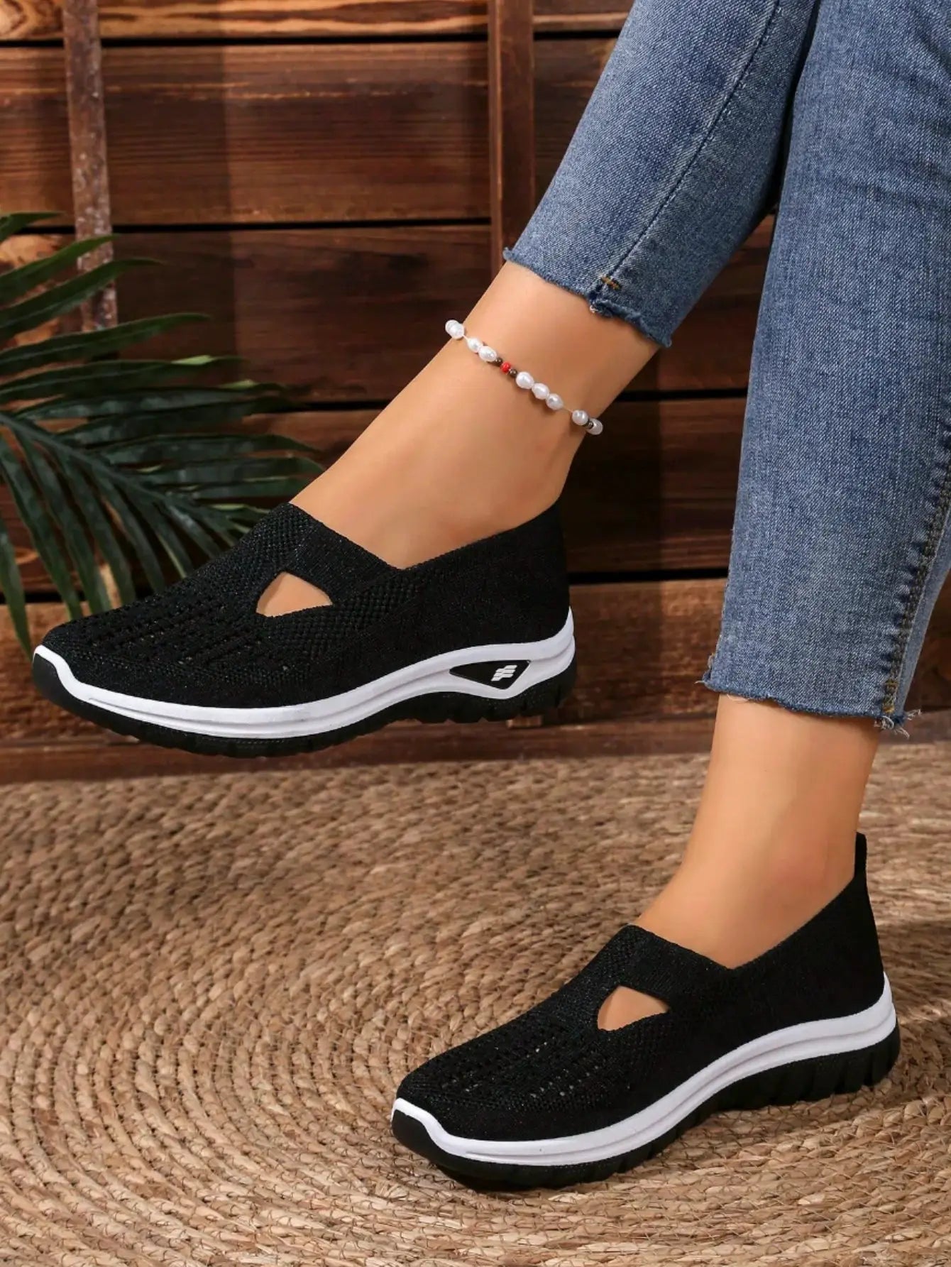 Women's casual mesh sneakers in black knit with white cushioned wedge sole and cut-out detail
