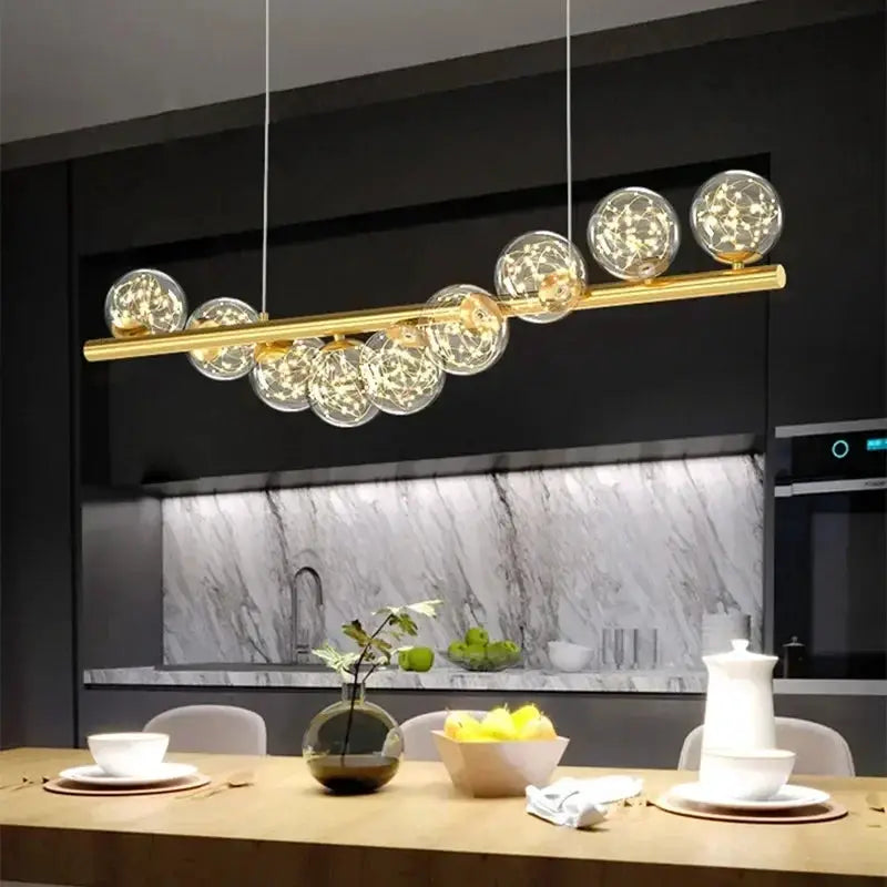 Nordic ceiling chandelier with a gold bar and clear glass globes, modern kitchen lighting