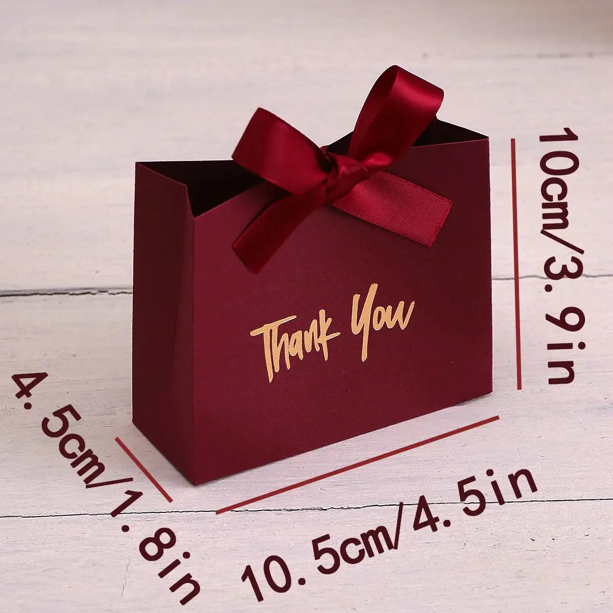 Mini burgundy gift box with gold Thank You text and red satin bow.