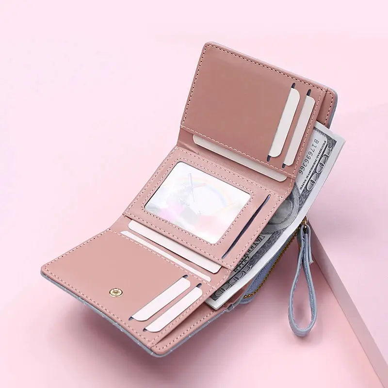 Women's pink PU tri-fold wallet with card slots, ID window, cash compartment, and zip pocket.